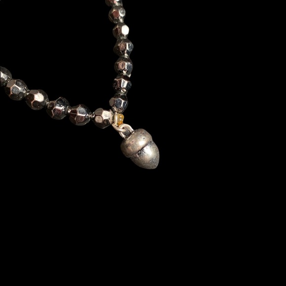 Black bracelet with metal piece hanging - Picture 3 of 5